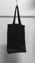 A usefull black shoulder bag with a patched pocket in the front. It is made in Berlin German.    Size: 32cm x 42cm x 11cm Colour: black Material: overgarment 70% cotton, 10%PE, 20% fake leather                lining 100% PE