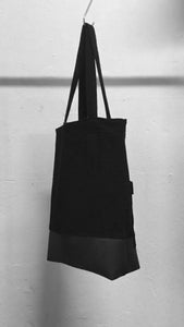 A usefull black shoulder bag with a patched pocket in the front. It is made in Berlin German.    Size: 32cm x 42cm x 11cm Colour: black Material: overgarment 70% cotton, 10%PE, 20% fake leather                lining 100% PE