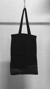 A usefull black shoulder bag with a patched pocket in the front. It is made in Berlin German.    Size: 32cm x 42cm x 11cm Colour: black Material: overgarment 70% cotton, 10%PE, 20% fake leather                lining 100% PE