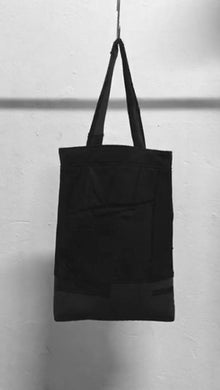 A usefull black shoulder bag out of material mix with raw-edges and a patched pocket in the front. It is made in Berlin German.        Size: 32cm x 42cm x 11cm Colour: black Material: overgarment 60% cotton, 10%wool, 5% spandex, 5%PE,                                     20% fake leather                          lining 100% PE